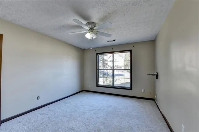 a bathroom with a granite countertop sink a large mirror and a shower
