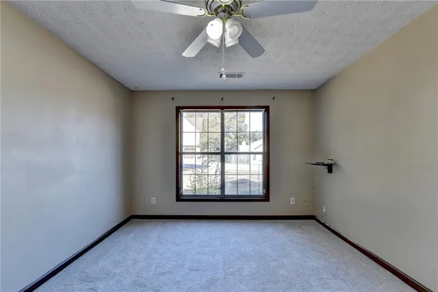 a bathroom with a granite countertop sink a large mirror and a shower