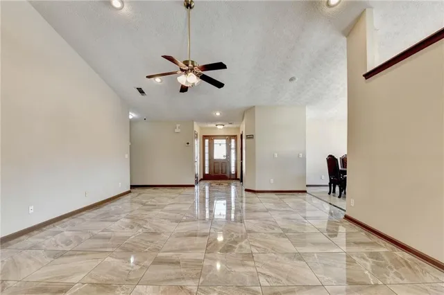 a view of a livingroom with a ceiling fan and window