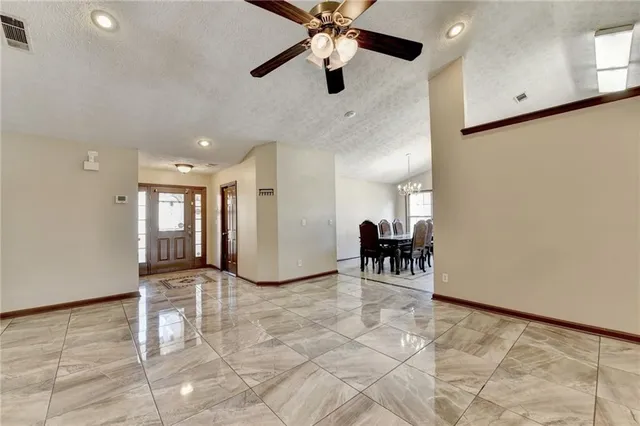 a view of livingroom with furniture and a chandelier fan
