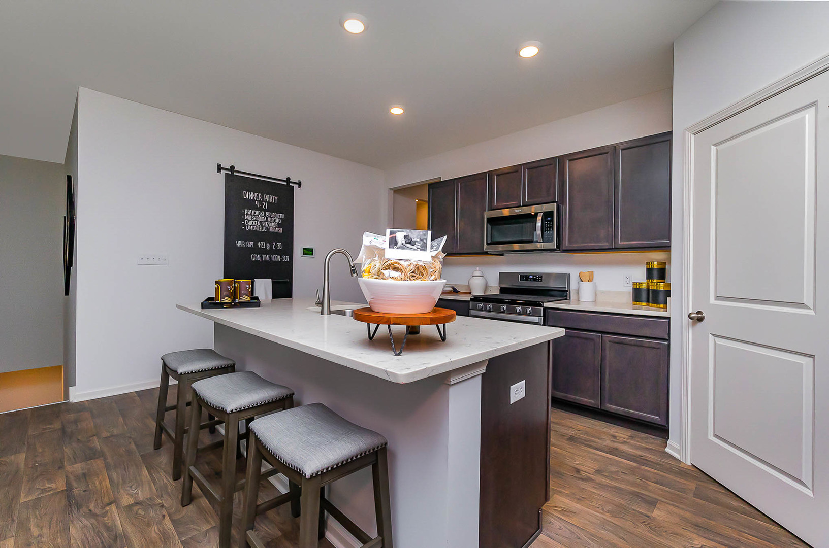 7600 West 105th Place Crown Point, IN 46307 - Photo 13 of 34 a kitchen with a sink cabinets and wooden floor