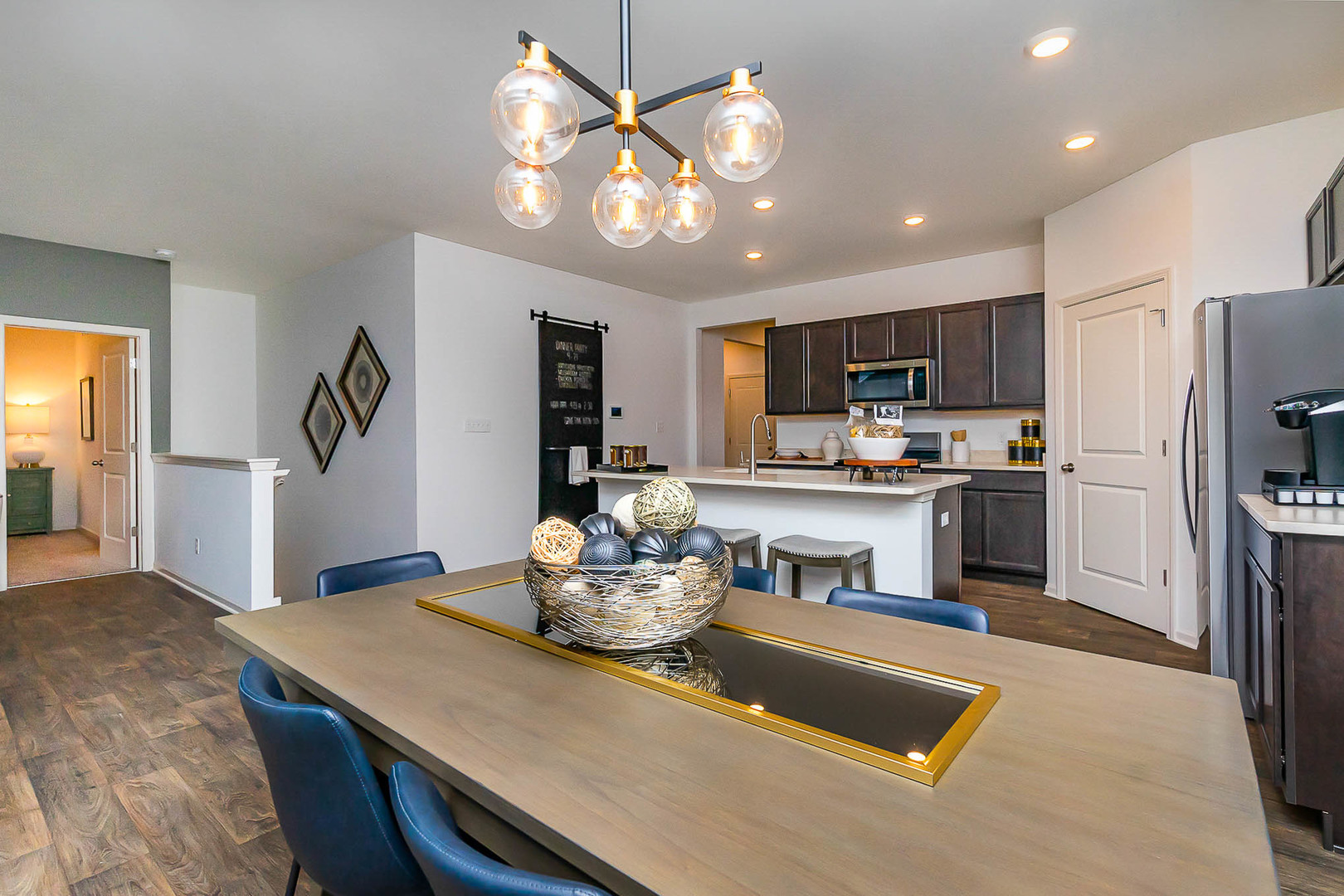 7600 West 105th Place Crown Point, IN 46307 - Photo 17 of 34 a kitchen with a table chairs refrigerator and microwave