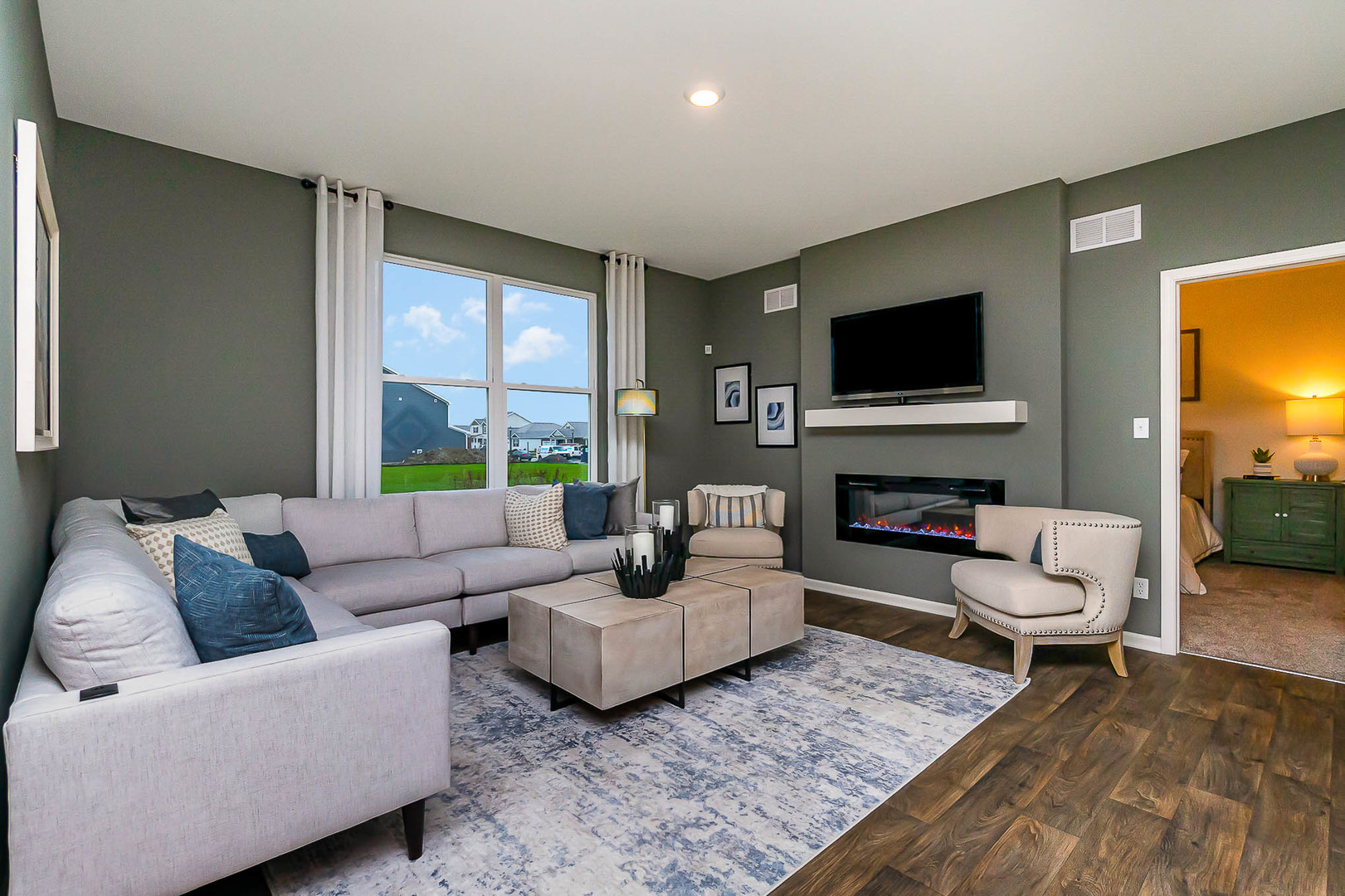 7600 West 105th Place Crown Point, IN 46307 - Photo 18 of 34 a living room with furniture and a flat screen tv