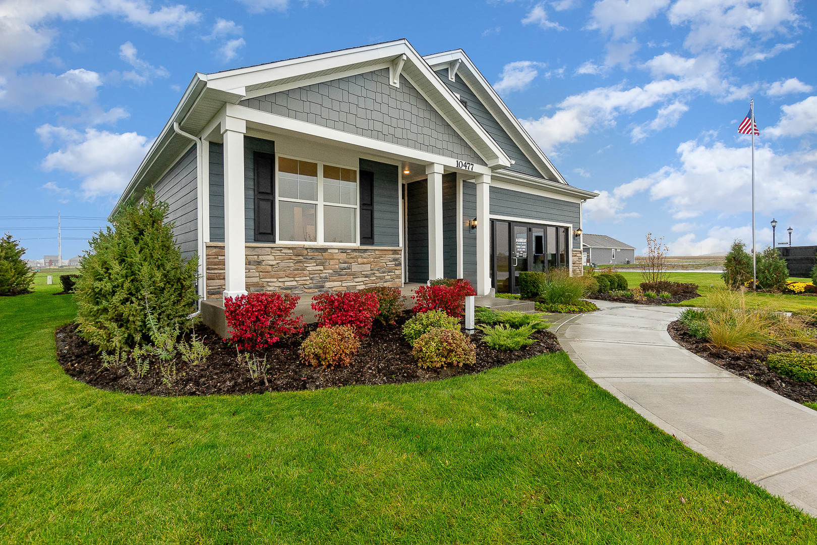 7600 West 105th Place Crown Point, IN 46307 - Photo 2 of 34 a front view of a house with a garden