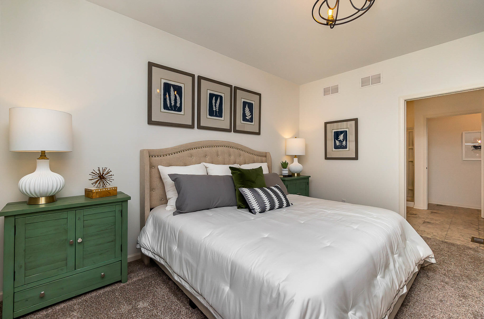 7600 West 105th Place Crown Point, IN 46307 - Photo 21 of 34 a bedroom with a large bed and a lamp on table
