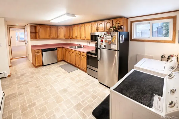 a kitchen with stainless steel appliances granite countertop a refrigerator and a stove top oven