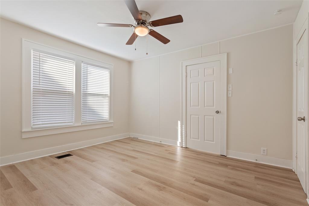 1624 North 17th Street Waco, TX 76707 - Photo 19 of 34 an empty room with wooden floor ceiling fan and windows