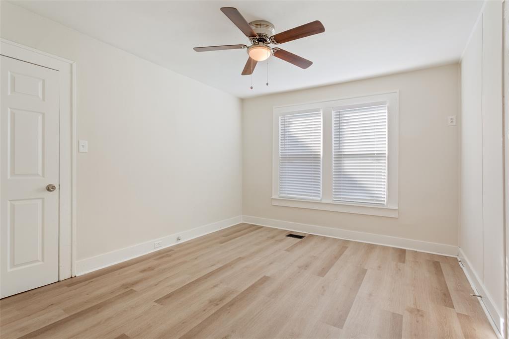 1624 North 17th Street Waco, TX 76707 - Photo 20 of 34 an empty room with wooden floor ceiling fan and windows