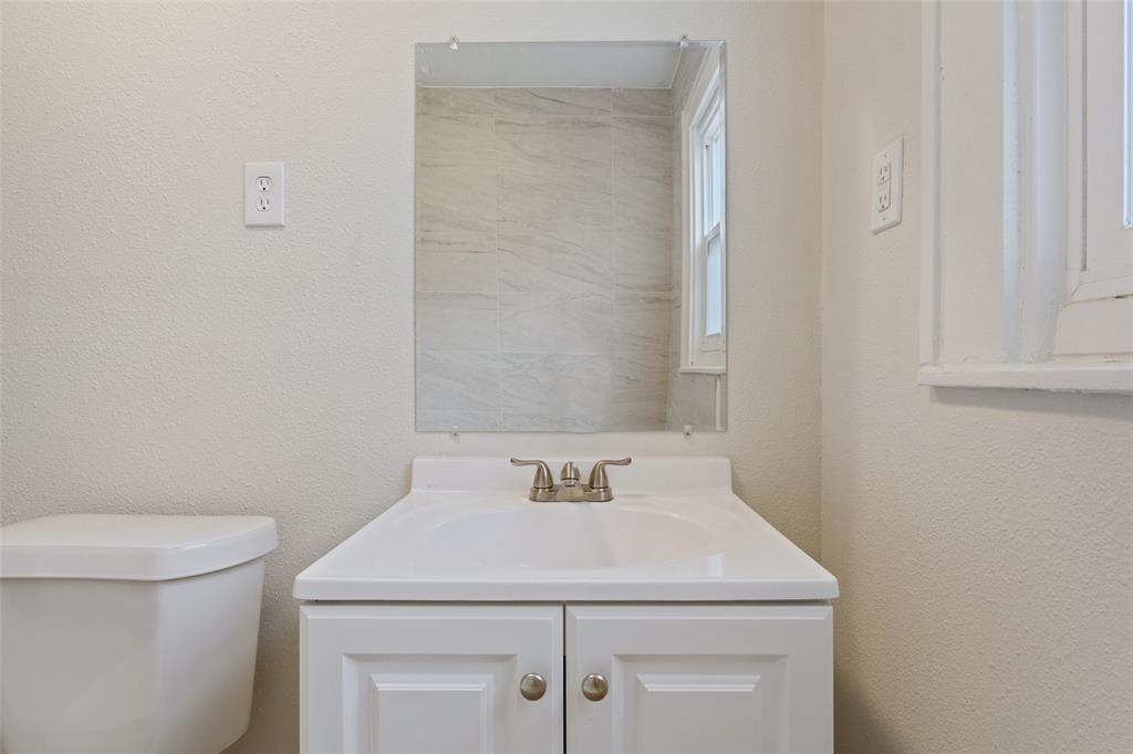 1624 North 17th Street Waco, TX 76707 - Photo 28 of 34 a bathroom with a sink a toilet and vanity