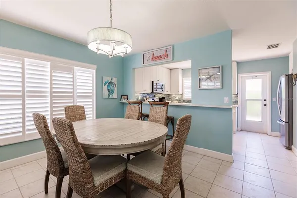 a view of a dining room with furniture and window