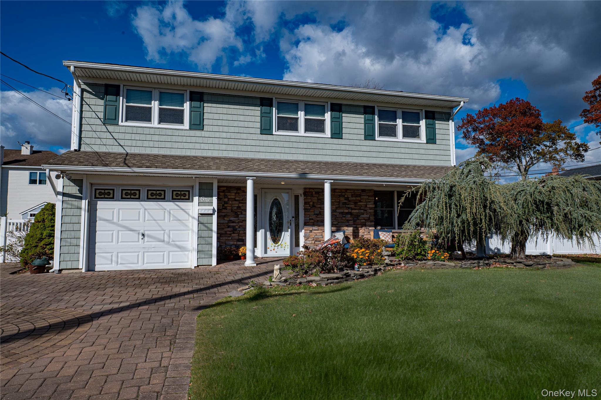 a front view of a house with a garden and porch