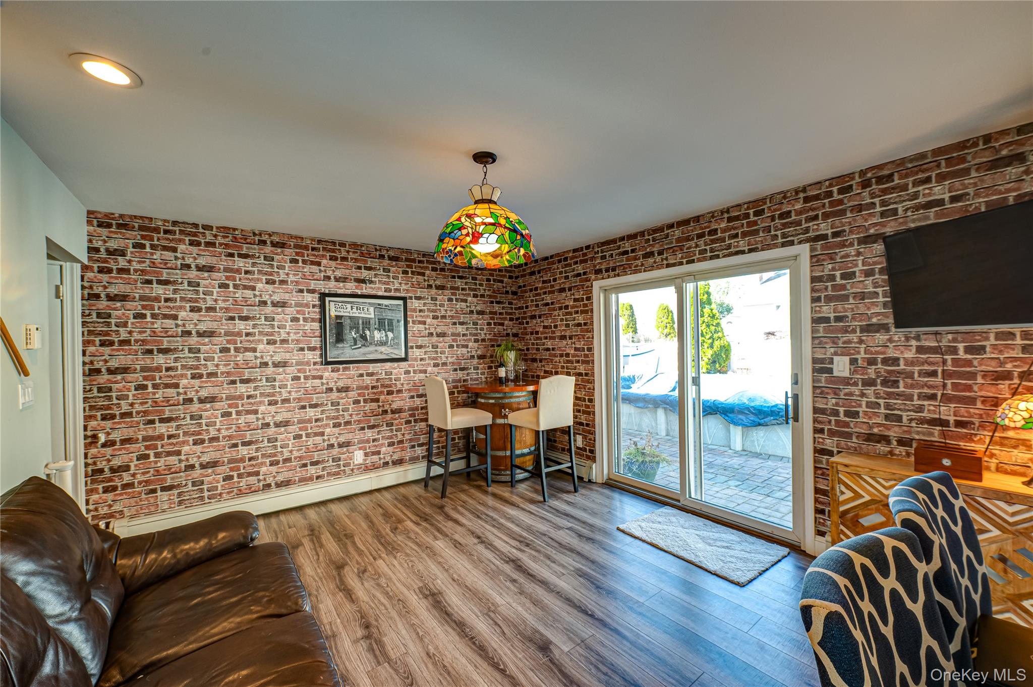 1 Freedom Court Babylon, NY 11702 - Photo 12 of 23 a view of livingroom with furniture window and wooden floor