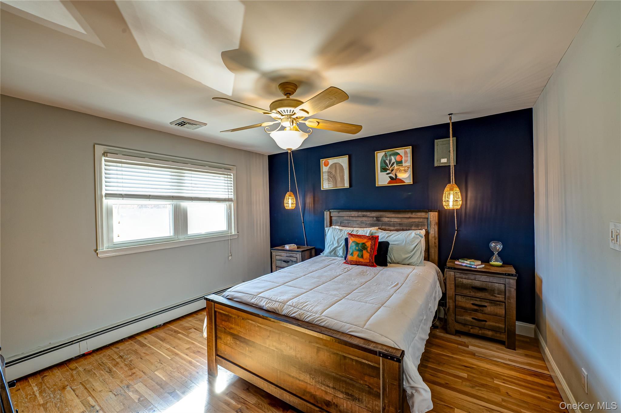 1 Freedom Court Babylon, NY 11702 - Photo 15 of 23 a bedroom with a bed and a chandelier