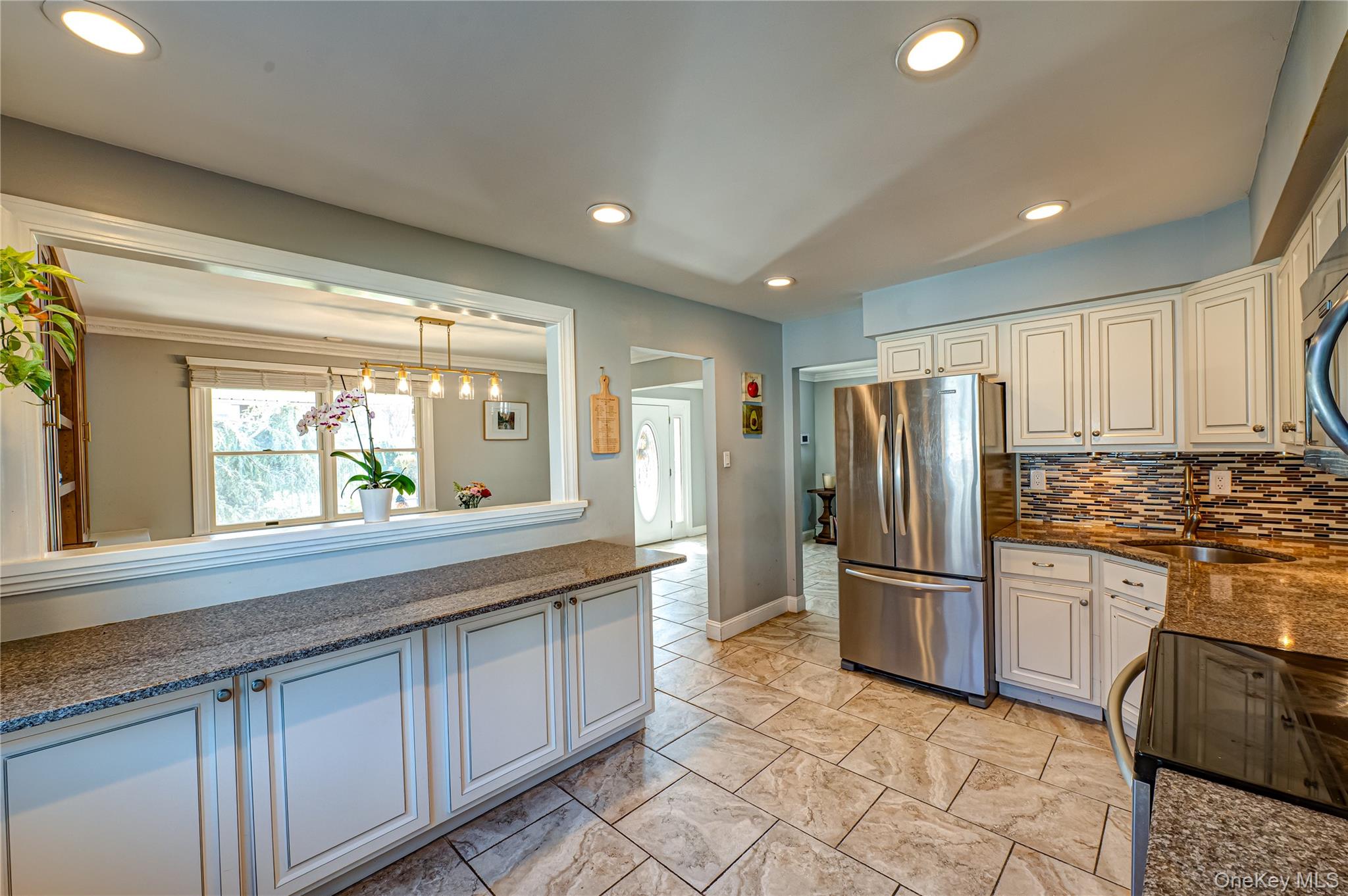 1 Freedom Court Babylon, NY 11702 - Photo 9 of 23 a kitchen with stainless steel appliances granite countertop a refrigerator and a sink