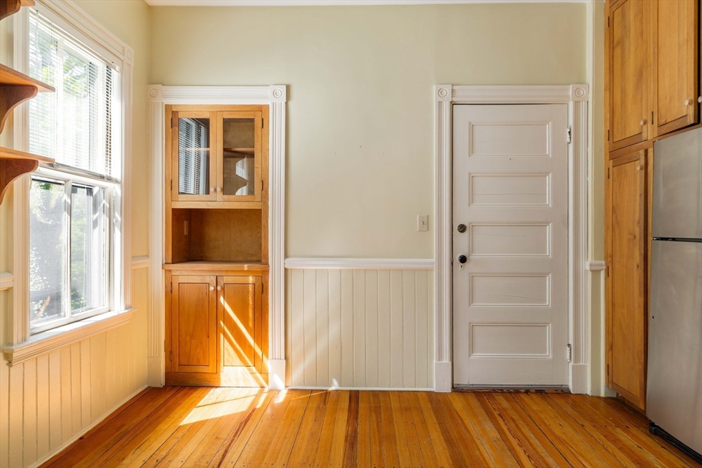 259 Upland Road Cambridge, MA 02138 - Photo 24 of 38 an empty room with wooden floor and windows