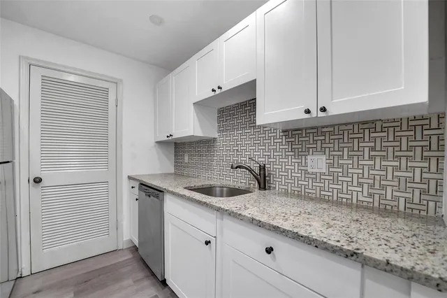 a kitchen with a sink and cabinets
