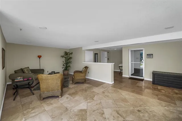a view of a tall building with a yard and potted plants