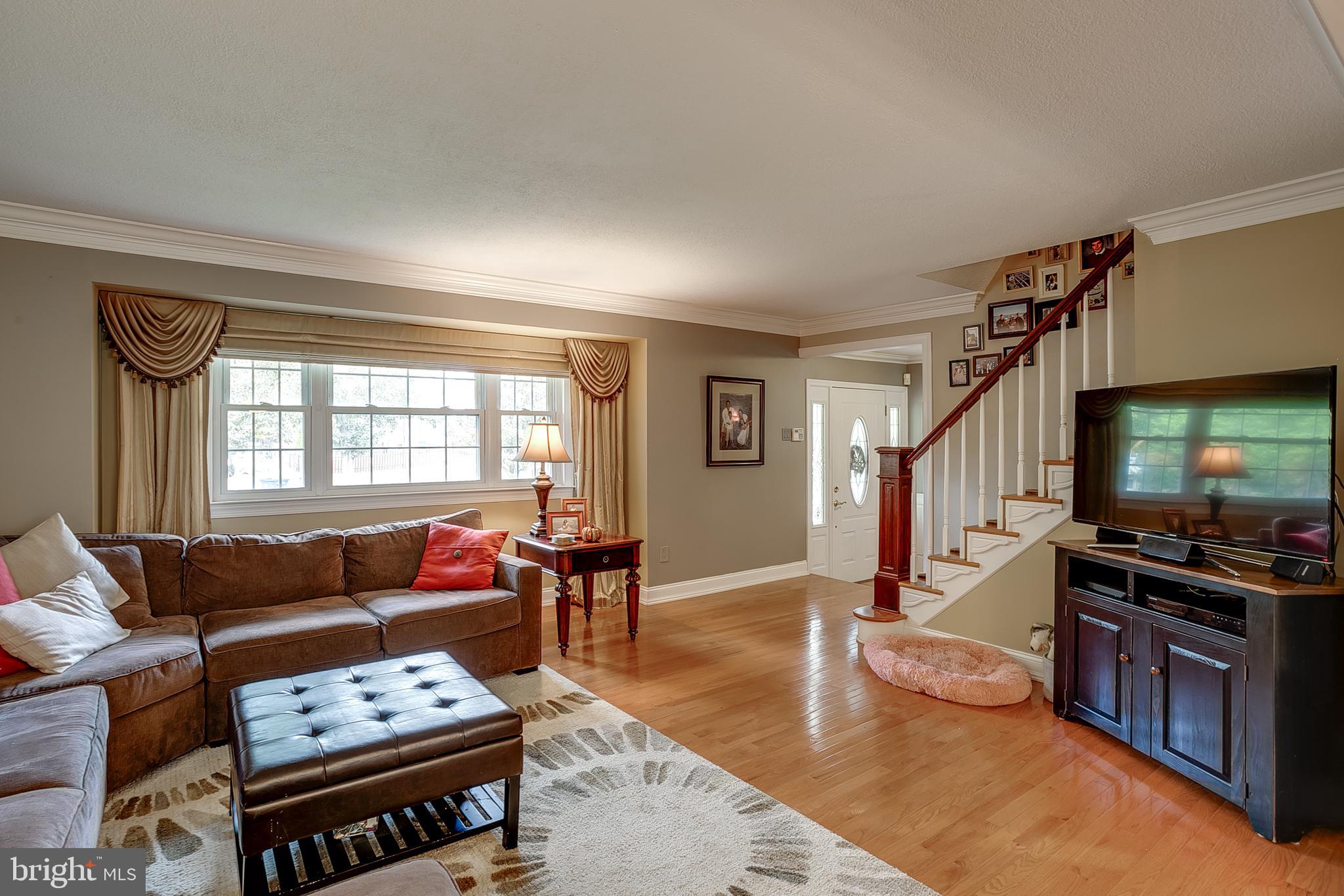 233 Hamilton Road Marlton, NJ 08053 - Photo 13 of 48 a living room with furniture a wooden floor and a window