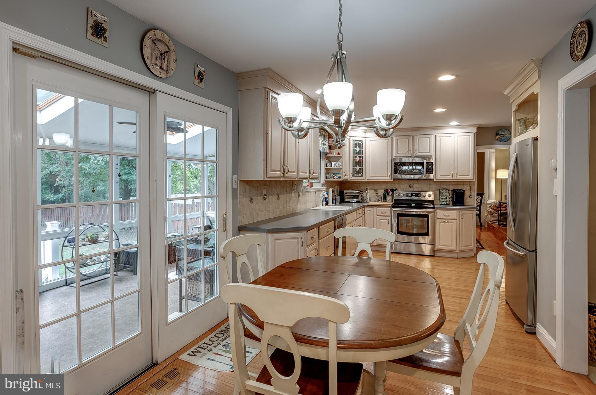 233 Hamilton Road Marlton, NJ 08053 - Photo 21 of 48 a kitchen with stainless steel appliances granite countertop a stove a refrigerator a kitchen island a table and chairs