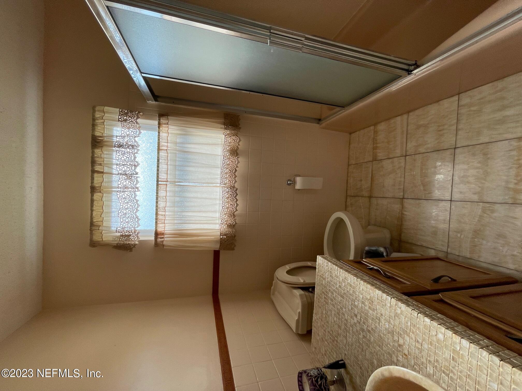 1042 Jamaica Road East Jacksonville, FL 32216 - Photo 22 of 59 a bathroom with a sink and mirror