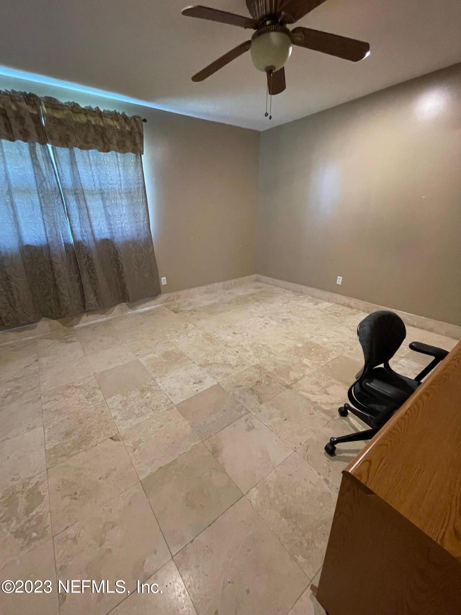 1042 Jamaica Road East Jacksonville, FL 32216 - Photo 33 of 59 a room with a bed and cabinets