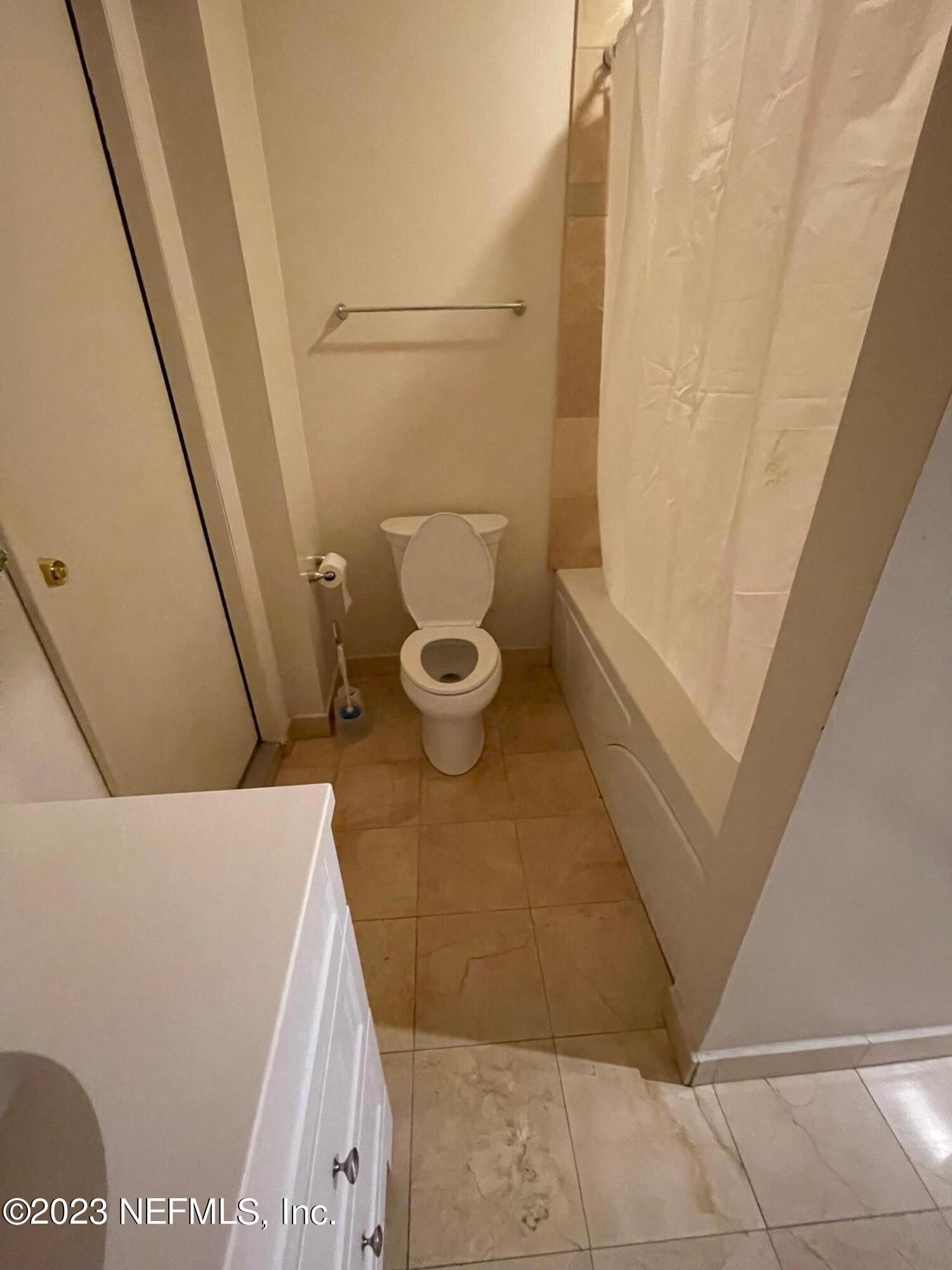 1042 Jamaica Road East Jacksonville, FL 32216 - Photo 37 of 59 a bathroom with a granite countertop sink and a toilet