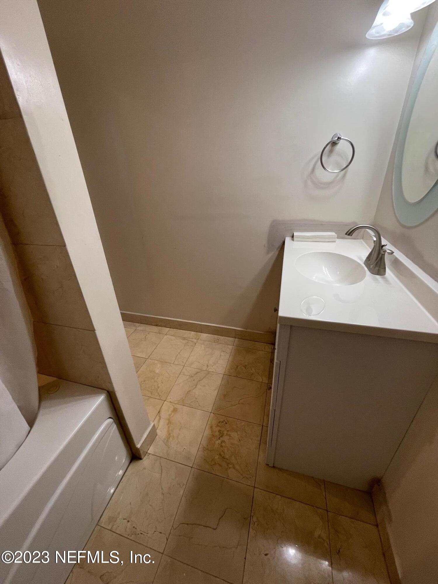 1042 Jamaica Road East Jacksonville, FL 32216 - Photo 38 of 59 a bathroom with a sink and a mirror