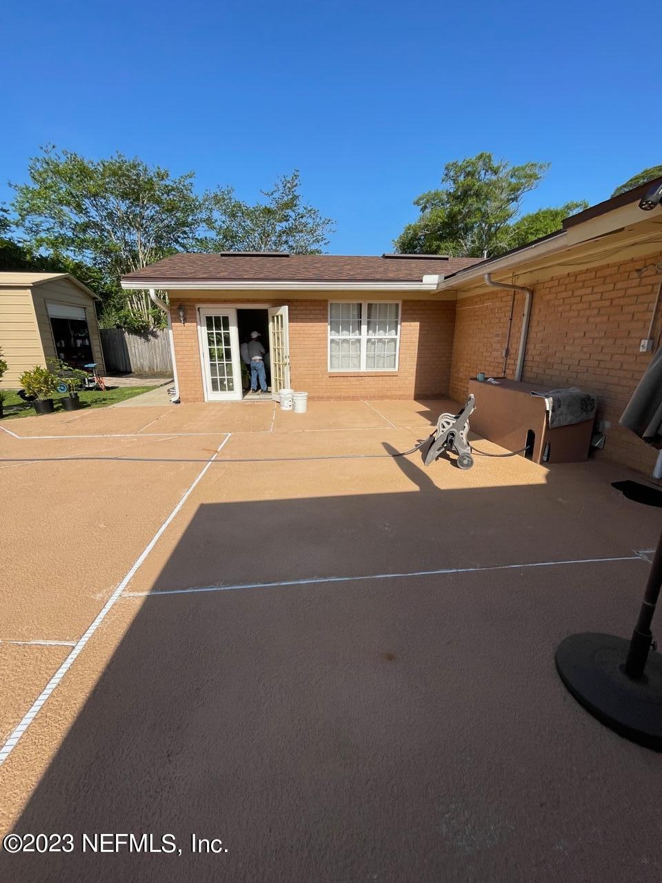 1042 Jamaica Road East Jacksonville, FL 32216 - Photo 52 of 59 a backyard of a house with basket ball court and outdoor seating