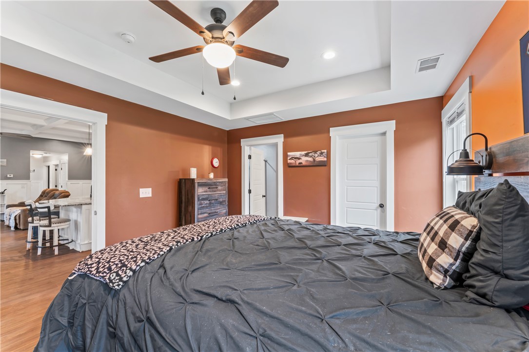 429 Nelson Drive Anderson, SC 29621 - Photo 14 of 32 Well-lit sleeping quarters with a ceiling fan, offering a warm and inviting atmosphere.