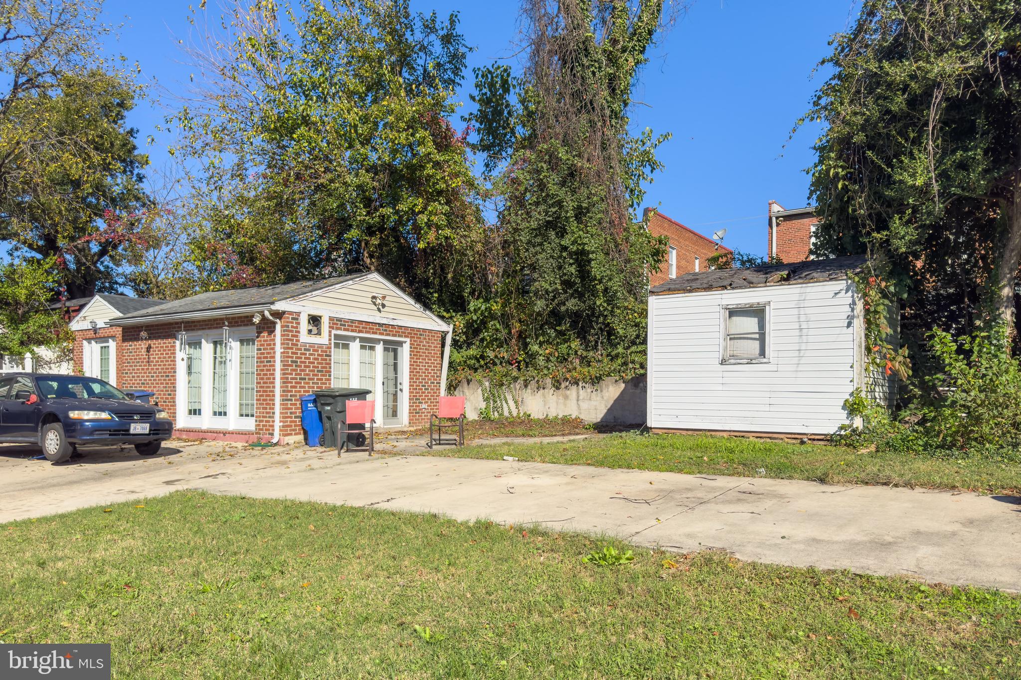 5432 Call Place Southeast Washington, DC 20019 - Photo 4 of 6 a front view of a house with a yard and garage