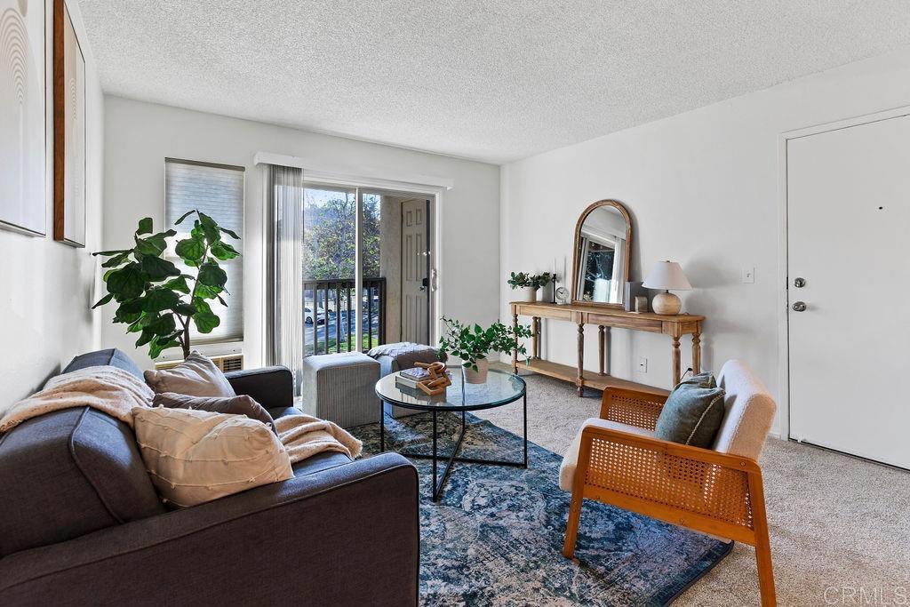 5918 Rancho Mission Road, Unit 62 San Diego, CA 92108 - Photo 11 of 37 a living room with furniture and a potted plant