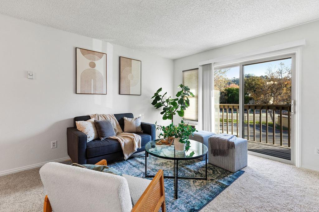 5918 Rancho Mission Road, Unit 62 San Diego, CA 92108 - Photo 12 of 37 a living room with furniture and a potted plant