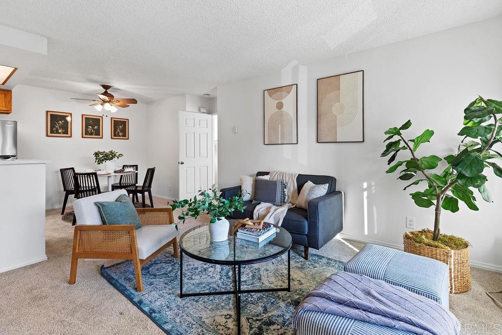 5918 Rancho Mission Road, Unit 62 San Diego, CA 92108 - Photo 13 of 37 a living room with furniture potted plant and a window