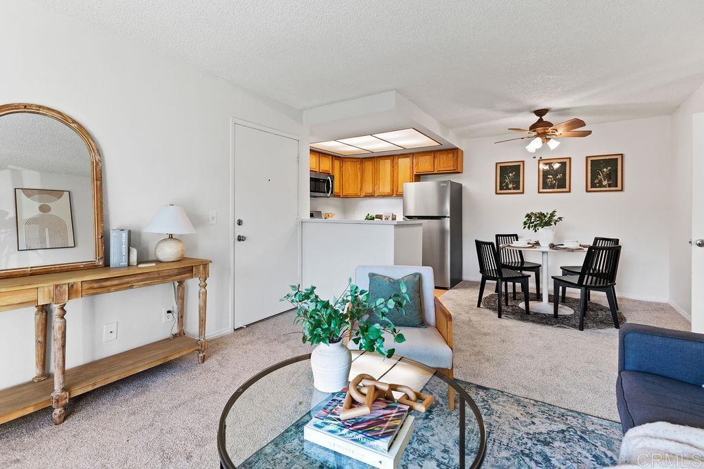 5918 Rancho Mission Road, Unit 62 San Diego, CA 92108 - Photo 14 of 37 a living room with stainless steel appliances kitchen island granite countertop furniture and a kitchen view