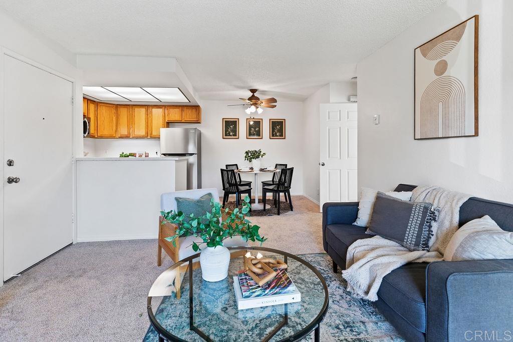 5918 Rancho Mission Road, Unit 62 San Diego, CA 92108 - Photo 15 of 37 a living room with furniture and wooden floor