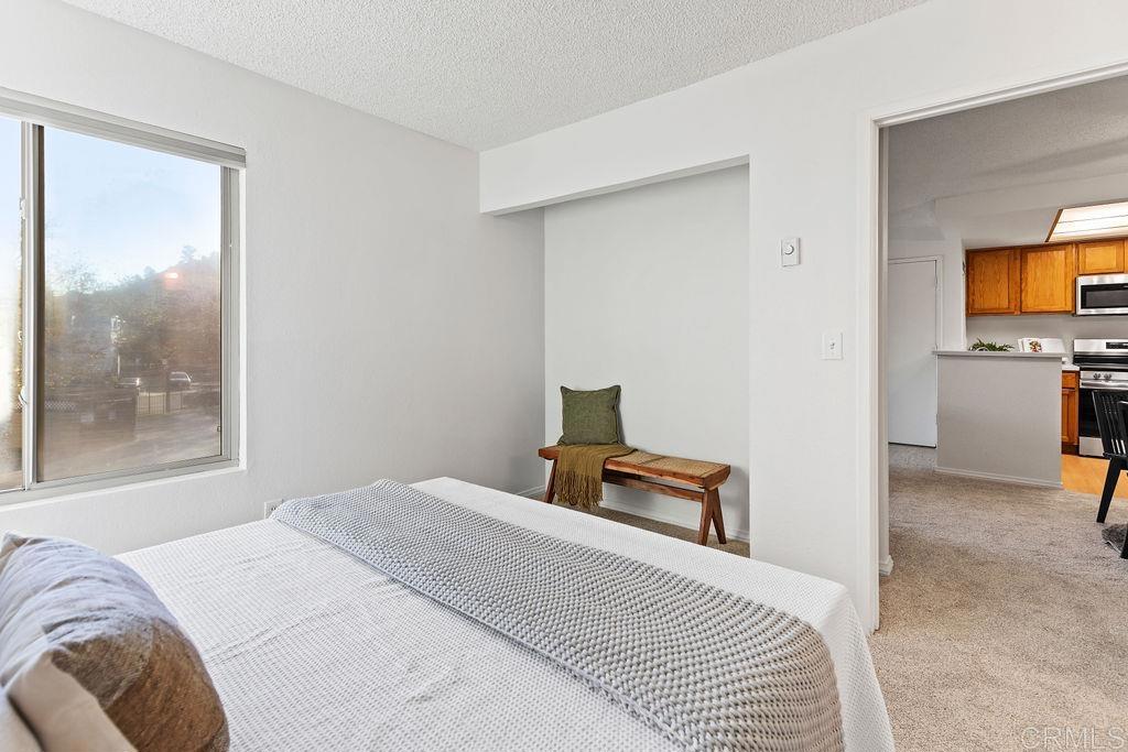 5918 Rancho Mission Road, Unit 62 San Diego, CA 92108 - Photo 17 of 37 a bedroom with furniture and a window