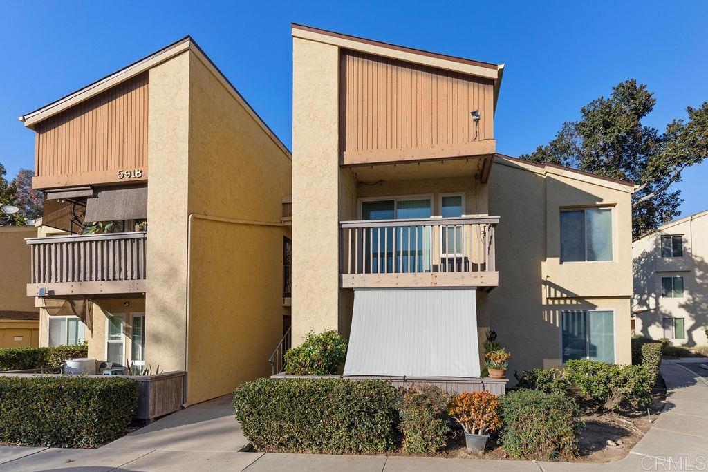 5918 Rancho Mission Road, Unit 62 San Diego, CA 92108 - Photo 2 of 37 a front view of a house with a yard