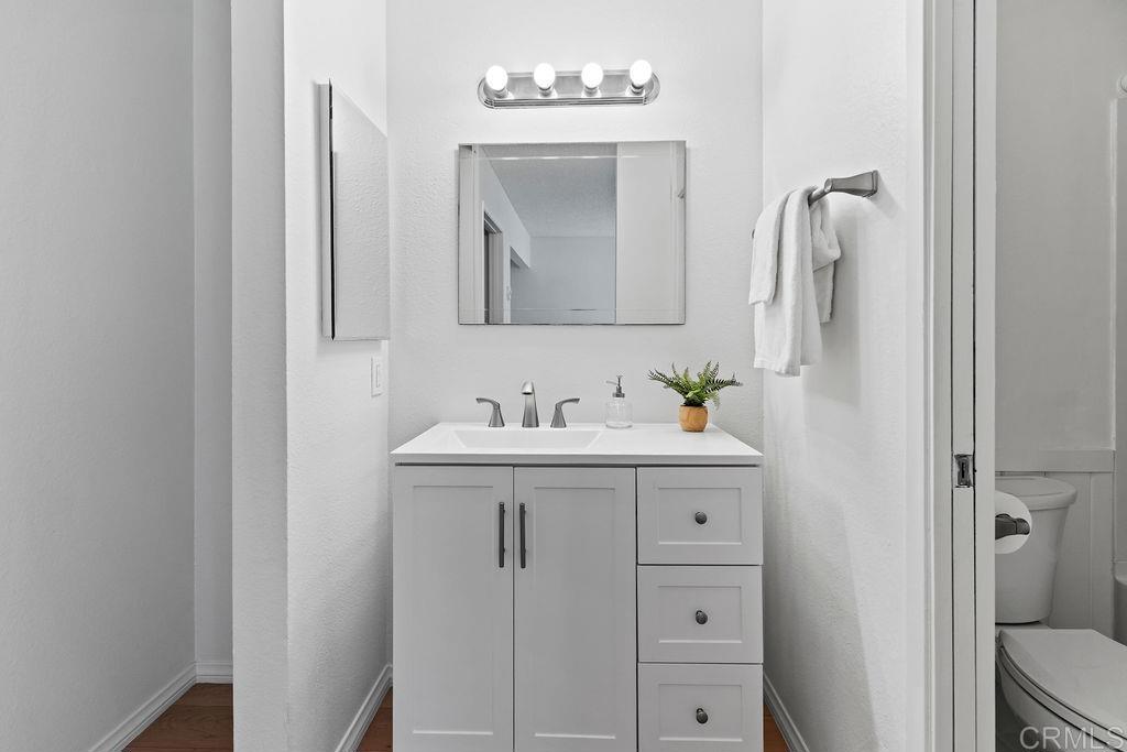 5918 Rancho Mission Road, Unit 62 San Diego, CA 92108 - Photo 21 of 37 a bathroom with a sink vanity and a mirror