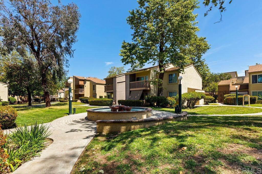 5918 Rancho Mission Road, Unit 62 San Diego, CA 92108 - Photo 29 of 37 a view of a house with a yard and street
