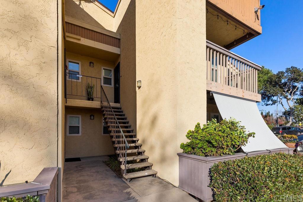 5918 Rancho Mission Road, Unit 62 San Diego, CA 92108 - Photo 3 of 37 a front view of a house with a yard