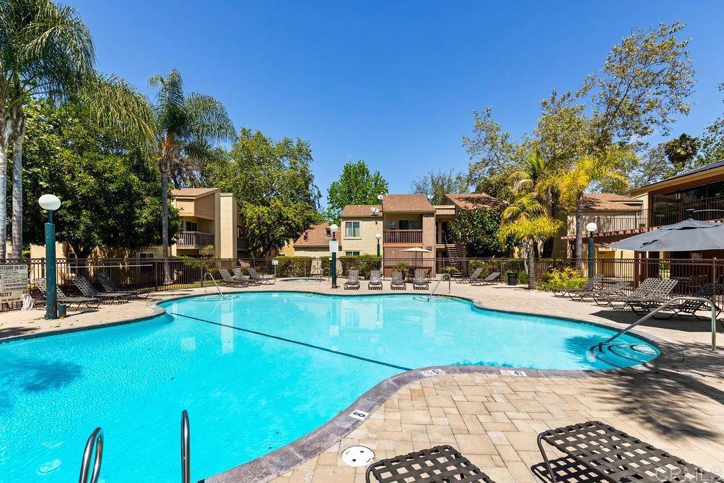 5918 Rancho Mission Road, Unit 62 San Diego, CA 92108 - Photo 31 of 37 a view of a swimming pool with a lounge chairs