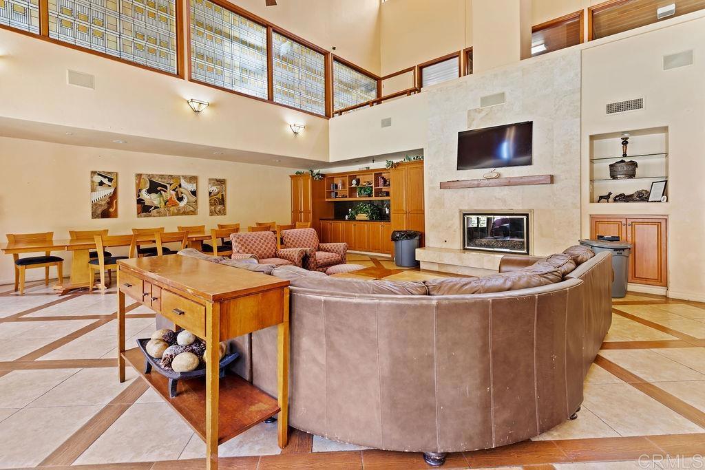 5918 Rancho Mission Road, Unit 62 San Diego, CA 92108 - Photo 34 of 37 a living room with fireplace furniture and a flat screen tv