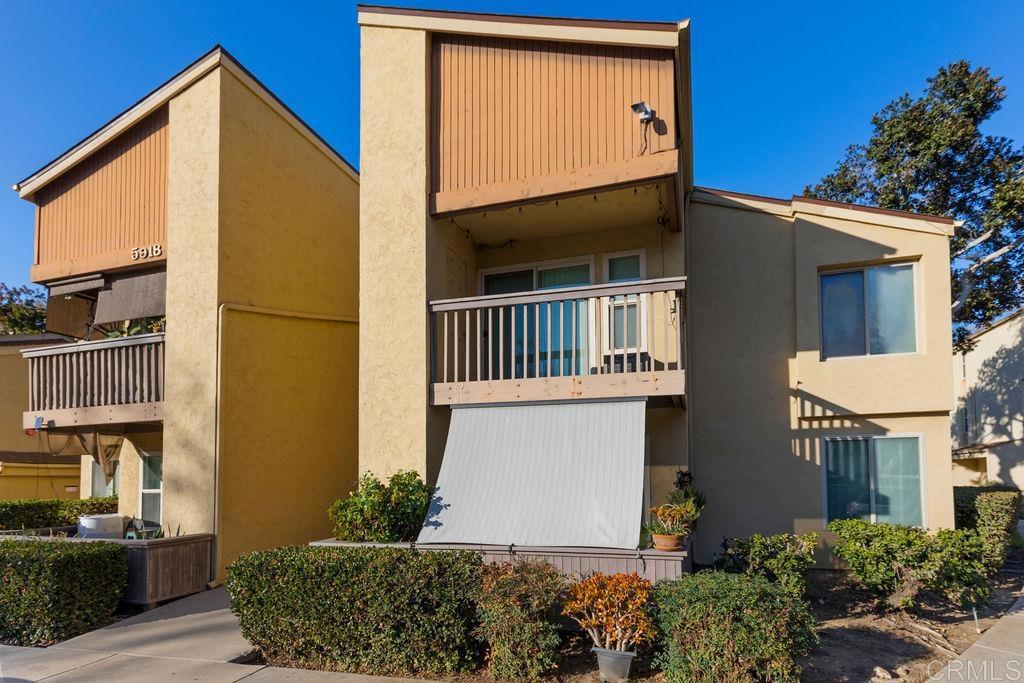 5918 Rancho Mission Road, Unit 62 San Diego, CA 92108 - Photo 37 of 37 a front view of a house with a yard