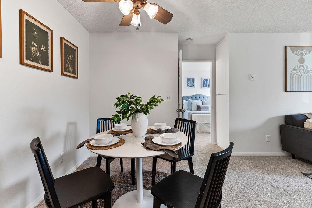 5918 Rancho Mission Road, Unit 62 San Diego, CA 92108 - Photo 8 of 37 a view of a dining room with furniture and wooden floor