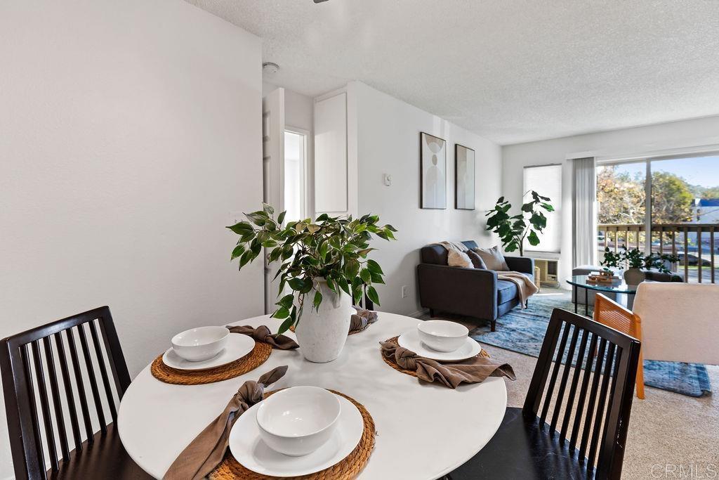 5918 Rancho Mission Road, Unit 62 San Diego, CA 92108 - Photo 9 of 37 a view of a dining room with furniture window and wooden floor