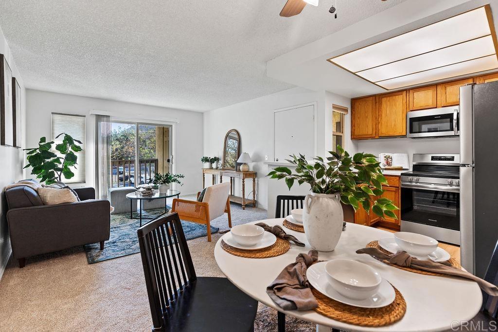 5918 Rancho Mission Road, Unit 62 San Diego, CA 92108 - Photo 10 of 37 a view of a dining room with furniture window and wooden floor