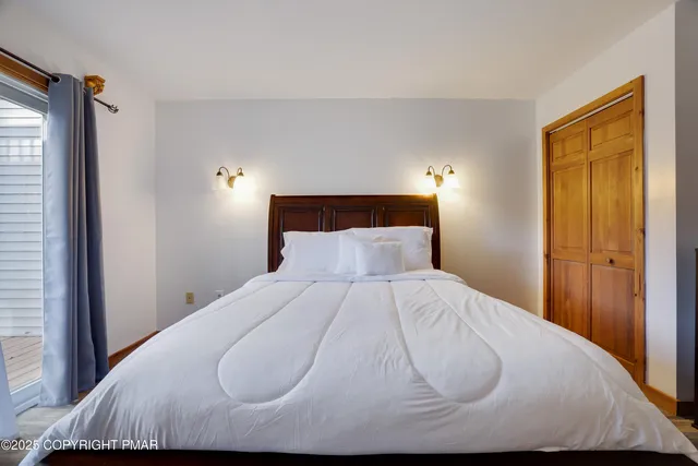 a bed sitting in a bedroom next to a window