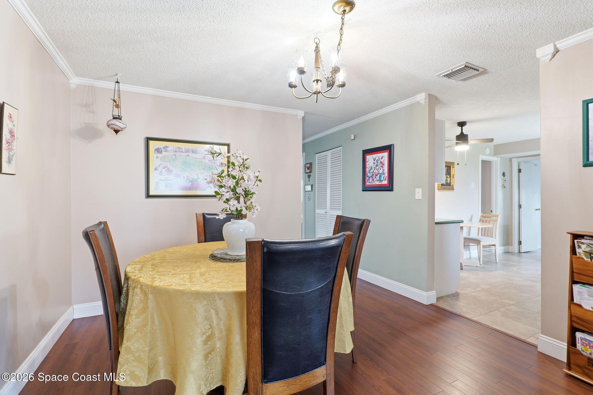 908 Jefferson Road Rockledge, FL 32955 - Photo 5 of 37 a dining room with furniture wooden floor a rug and a chandelier