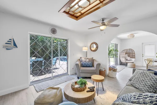 a living room with furniture a fireplace and a large window