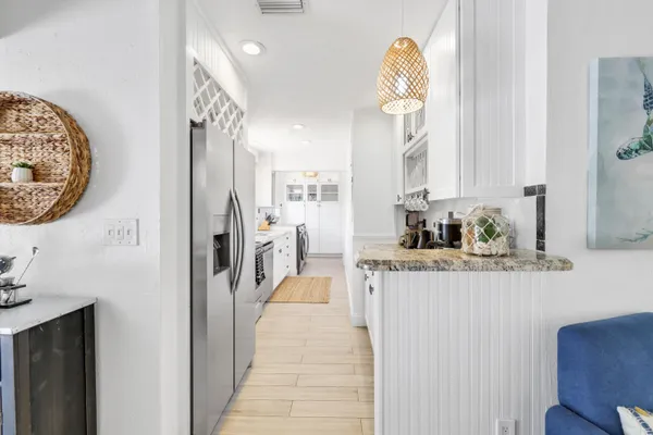 a kitchen with stainless steel appliances granite countertop a refrigerator and a stove